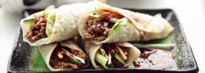 Chinese pancakes with duck, vegetables and hoisin sauce