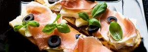 Parma ham, black olives, brie cheese and basil sandwich