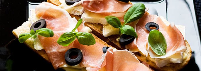 Parma ham, black olives, brie cheese and basil sandwich