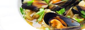 Clams with brown rice in saffron broth with celery