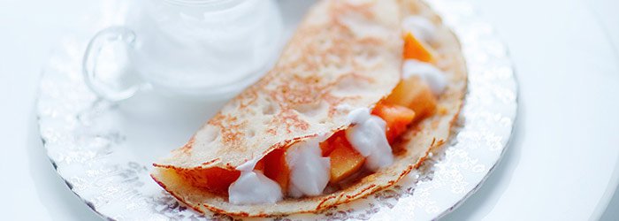 Coconut pancakes with papaya and coconut cream