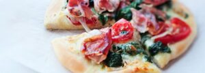 Pizza ze szpinakiem, szynką i pomidorami