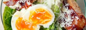 Caesar salad with egg and crispy bacon
