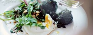 Salad with young beet greens and poached egg