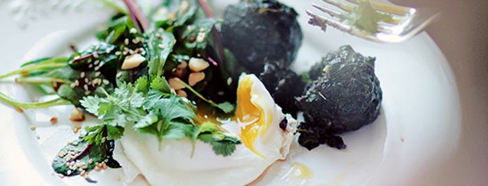 Salad with young beet greens and poached egg