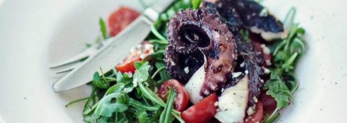 Salad with octopus, arugula and cherry tomatoes