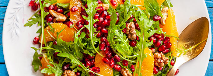 Arugula salad with pomegranate, orange and walnuts