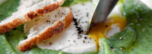 Broccoli soup with soft-boiled egg and truffle oil
