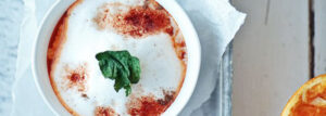 Cream tomato soup with orange and milk foam