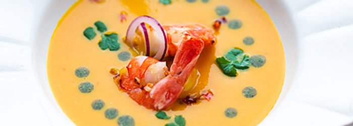 Creamy pumpkin soup with shrimp and cilantro pesto