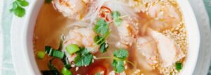Thai soup with shrimp, salmon, rice noodles and sesame